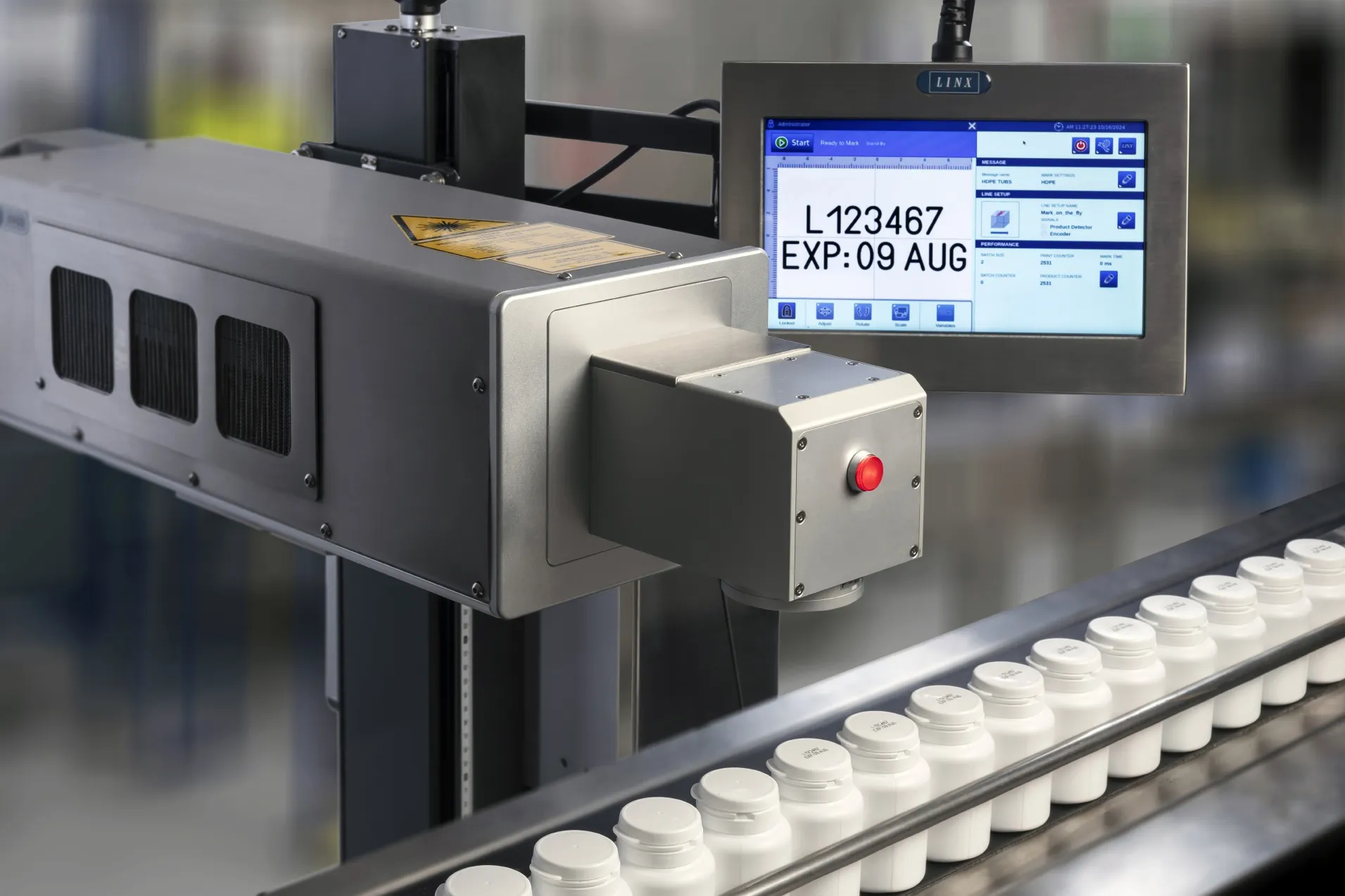 Linx UVG5 laser marking white bottles on a line
